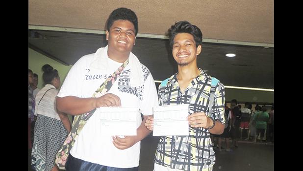 Two participants of the Summer Youth Employment Program smiling as they receive their first paychecks which were disbursed yesterday afternoon inside the EOB atrium. [photo: Sabrina Sinapati]