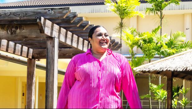 Aigalesala Toelupe in pink wearing her creation
