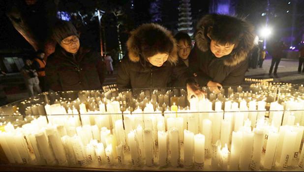 Buddhist light candles for New Year 2019
