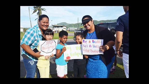 South Pacific Academy Teacher Maryanna Toilolo Ioane with her students Monday morning, as they join the Globe in celebrating “stomp out bullying.”  [Photo: JL]