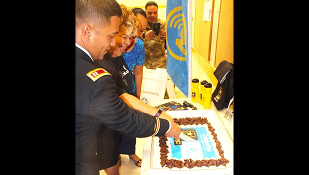 US Army Capt. Kurk Cruz Diaz, the Guam Recruitment Company Commander, with Bluesky official Sherry Sele, cutting the cake yesterday as part of the signing ceremony for the Army Partnership for Youth Success (PaYS) program with Bluesky Communications.  [photo: FS]