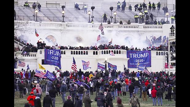 Violent protesters, loyal to President Donald Trump, storm the Capitol, Jan. 6, 2021, in Washington. (AP Photo/John Minchillo, File) Rioters breaking into U.S. Capitol on Jan. 6, 2021.
