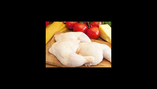 Pieces of chicken on a cutting board.