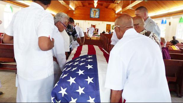 Pallbearers escorted into the Futiga Catholic Church last Thursday during the family service, the U.S. flag-draped coffin of Ulufaleilupe Fuimaono Ta’aala Leulua'ialii Filifaiesea Fa'asuamalie