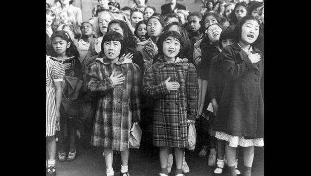 In this April 1942 file photo made available by the Library of Congress, children at the Weill public school in San Francisco recite the Pledge of Allegiance. Some of them are evacuees of Japanese ancestry who will be housed in War Relocation Authority centers for the duration of World War II. (Dorothea Lange/U.S. War Relocation Authority via AP, File) children at the Weill public school in San Francisco recite the Pledge of Allegiance. Some of them are evacuees of Japanese ancestry who will be housed in War Relocation Authority centers for the duration of World War II.
