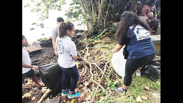 Students during a clean up project along the Pala Lagoon shoreline in Lions Park
