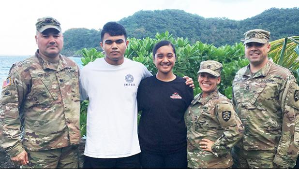 Cody McMoore (2nd from left) and Florine Roe (center) 