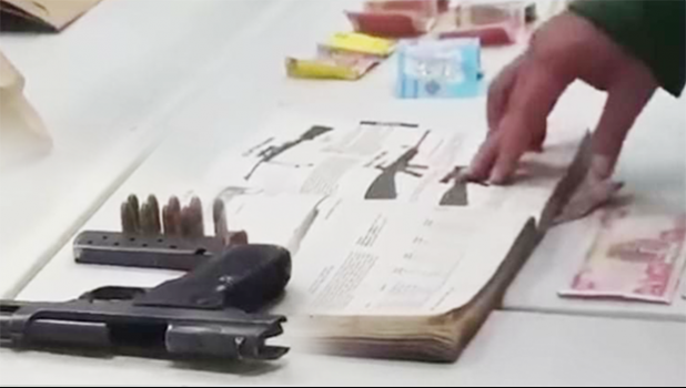 Iraqi money, illegal guns and ammunition, as well as a hardcover book with descriptions of various guns