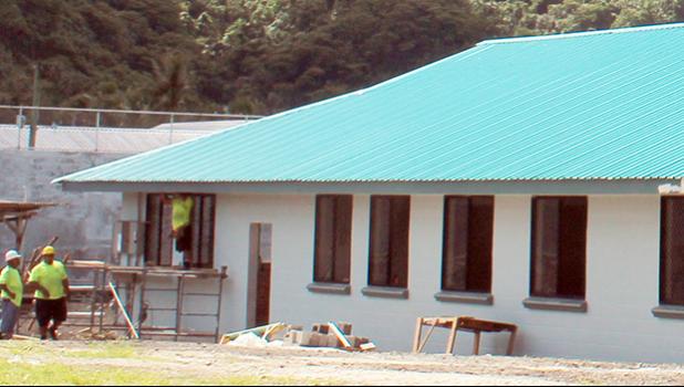 Construction workers at the new TAOA building going up in Tafuna.