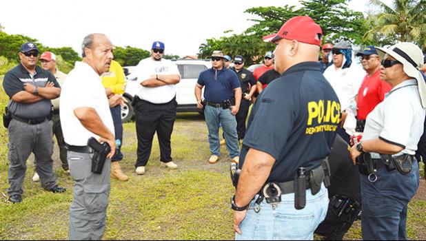 In this Oct. 10, 2017 file photo Ernie Haleck (middle) - the lead instructor in Firearms and Tactics for the National Tactical Officers Association (NTOA) and DPS in American Samoa - briefing local police officers, on the last day of a 2-week training course that certifies them to carry weapons. [photo: AF]