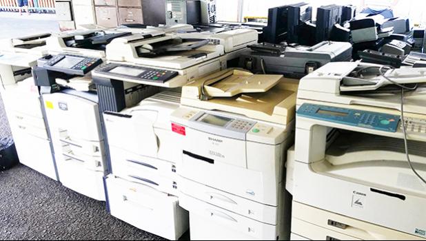 Some of the copy machines being auctioned off this week at the Office of Property Management. Items like used office equipment, kitchen appliances, jet skis and vehicles are being sold for pennies on the dollar during the auction.  [photo: Blue Chen-Fruean]