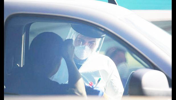 A man getting coronavirus test in drive through at Kakaako Waterfront Park in Hawaii.