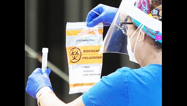 Healthcare worker with COVID-19 test kit