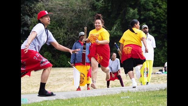 Teammates run after one of the women hit the ball during kirikiti action at Jefferson Park. Instead of prim British whites, Samoan players wear colorful ie lavalava. (Ellen M. Banner / The Seattle Times) Teammates running after one of the women hit the ball