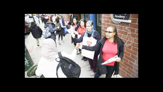 Teacher Pia Martin greets students as they arrive to school at the Science Leadership Academy as teachers take part in "A Day Without a Woman" demonstration in Philadelphia, Wednesday, March 8, 2017. Organizers of January's Women's March are calling on women to stay home from work and not spend money in stores or online to show their impact on American society. (AP Photo/Matt Rourke)
