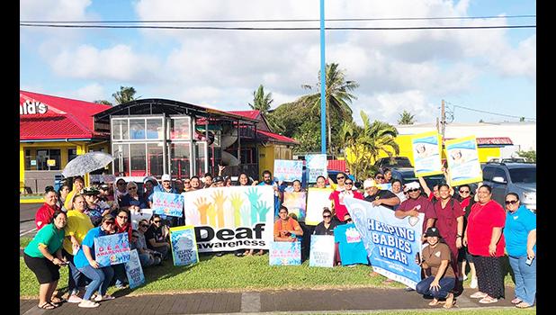 Deaf Awareness Month wave in front of McDonald's