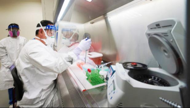 State Microbiologist Mark Nagata demonstrates extracting nucleic acid at the Hawaii State Laboratory