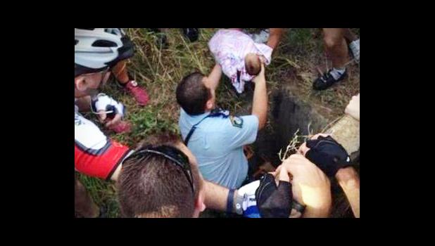 The dramatic moment the baby was rescued after five days down a 2.4m drain where he was left by his mother in November 2014. [photo / supplied]