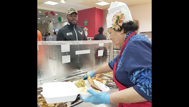 Congresswoman Aumua Amata dishing up food for troops