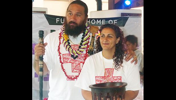 Denver Bronco’s Domata Peko (left) and his wife Ann