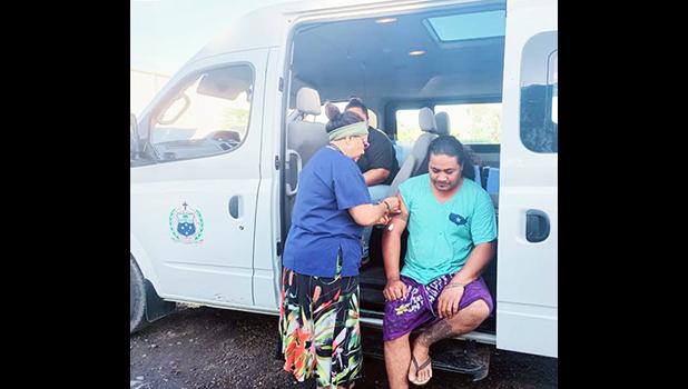Nurse giving man a vaccination in the Public Health van