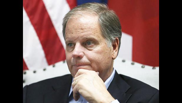 In this photo Dec, 13, 2017 file photo, Democrat Doug Jones speaks during an interview with the Associated Press, in Birmingham, Ala. Alabama Secretary of State John Merrill dismissed the viral story that over 5,000 of the votes for Jones in Tuesday’s special U.S. Senate election were cast by the dead. “There are not 5,000 dead people on the voters rolls unless they died today,” Merrill told the AP Thursday, Dec. 14. (AP Photo/John Bazemore, File) Democrat Doug Jones