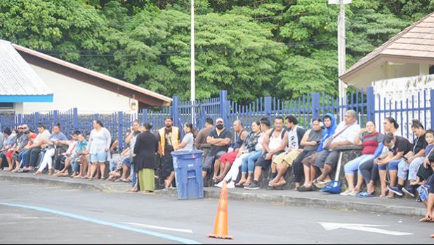 Crowds of people waiting for their Child Tax Credit payments in front of Lee Auditorium