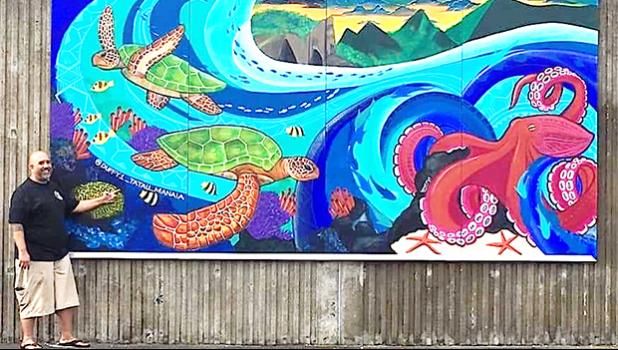 Duffy Hudson next to his mural