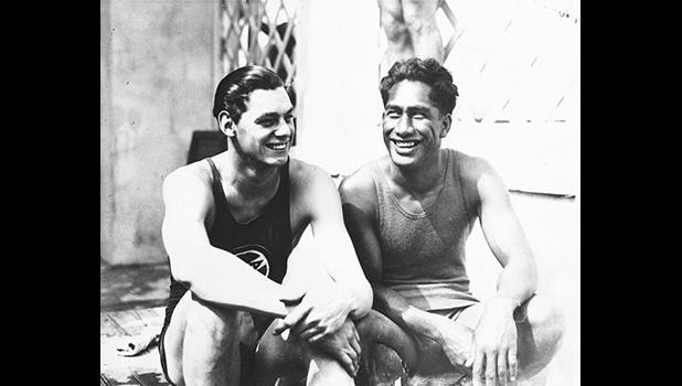 In this 1924 file photo, Johnny Weissmuller, left, and Duke Kahanamoku are seen at the 1924 Olympic games in Paris. For some Native Hawaiians, surfing's Olympic debut is both a celebration of a cultural touchstone invented by their ancestors, and an extension of the racial indignities seared into the history of the game and their homeland. Kahanamoku was a Native Hawaiian swimmer who won five Olympic medals and is known as the godfather of modern surfing who introduced the sport in surfing exhibitions in Australia and California. (AP Photo/File) Johnny Weissmuller, left, and Duke Kahanamoku