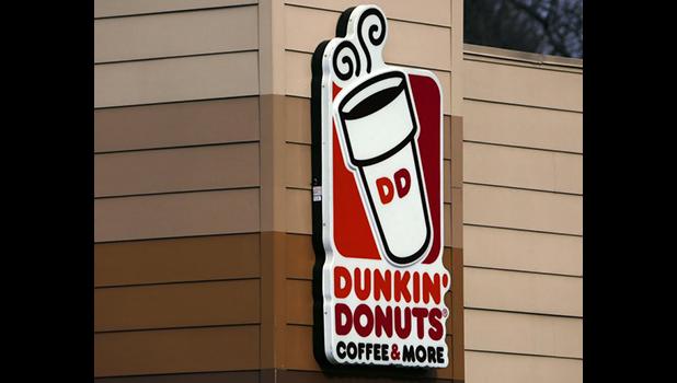 This Jan. 22, 2018, file photo shows the Dunkin’ Donuts logo on a shop in Mount Lebanon, Pa. Dunkin’ Donuts says a story and clickable coupon being shared widely online that offers free boxes of doughnuts to celebrate its anniversary is false. (AP Photo/Gene J. Puskar, File) This Jan. 22, 2018, file photo shows the Dunkin’ Donuts logo on a shop in Mount Lebanon, Pa. Dunkin’ Donuts says a story and clickable coupon being shared widely online that offers free boxes of doughnuts to celebrate its anniversary is false. (AP Photo/Gene J. Puskar, File)