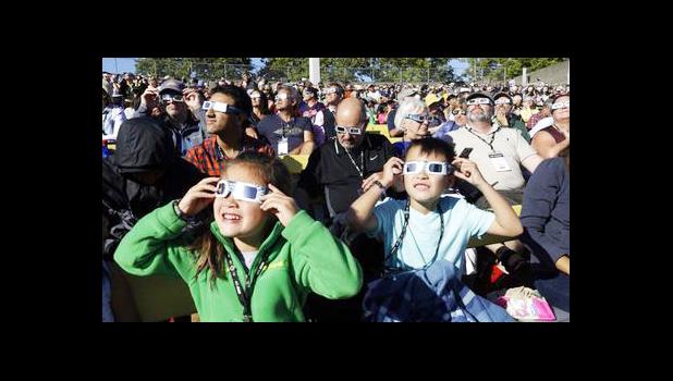 A crowd wears protective glasses as they watch the beginning of the solar eclipse from Salem, Ore., Monday, Aug. 21, 2017. (AP Photo/Don Ryan) A crowd wears protective glasses as they watch the beginning of the solar eclipse from Salem, Ore., Monday, Aug. 21, 2017. (AP Photo/Don Ryan)