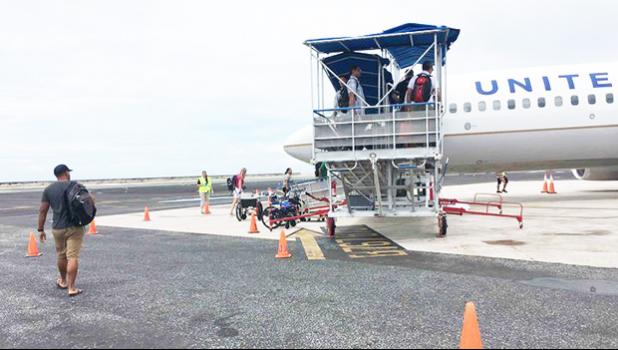  Passengers board a United Airlines flight in Majuro. For the first time in late January, Marshall Islands Immigration officials detained several passengers at Majuro's international airport for questioning in relation to participation in illegal adoptions in the United States. [Photo: Giff Johnson]