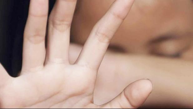 Photo of child with his hand up, indicating he is fending off an assault.