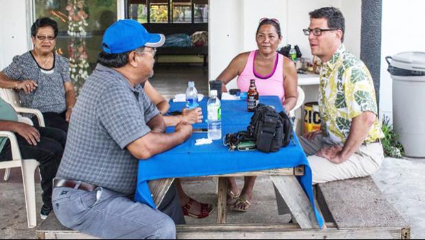 David Henkin (right) meets with Tinian residents 