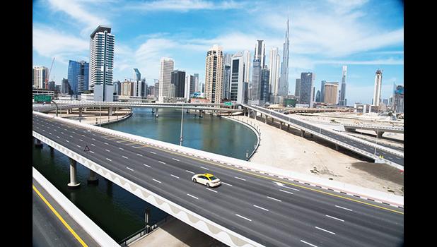 A lone taxi cab drives over a typically gridlocked highway with the Burj Khalifa, the world's tallest building, in the skyline behind it in Dubai, United Arab Emirates, Monday, April 6, 2020. Dubai, one of seven sheikdoms in the United Arab Emirates, is now under a 24-hour lockdown over the new coronavirus pandemic. (AP Photo/Jon Gambrell) A lone taxi cab drives over a typically gridlocked highway with