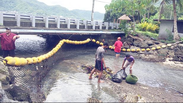 Aua Village was the first to complete the challenge "installation of marine debris encatchment net" on island, which was set up by American Samoa Power Authority and the village council. The net was set up at the stream on the main road of Aua. Aua 1st Ward of LDS faith adopted the stream and was very happy to have the net to help keep their coast clean and healthy. [photo: Ese Malala]