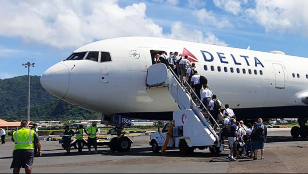 The last of the 29 missionaries of the Church of Jesus Christ of Latter Day Saints boarding the Delta Air Lines charter flight