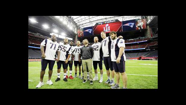  New England Patriots players pose for a photo during a walk through at NRG Stadium, site of the NFL Super Bowl 51 football game, Saturday, Feb. 4, 2017, in Houston. The Patriots will face the Atlanta Falcons in the Super Bowl Sunday. (AP Photo/Charlie Riedel)