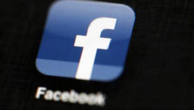 n this May 16, 2012, file photo, the Facebook logo is displayed on an iPad in Philadelphia. Facebook is updating its "trending" feature, which shows popular topics discussed and shared on its site, in an effort to root out fake news and misinformation. (AP Photo/Matt Rourke)