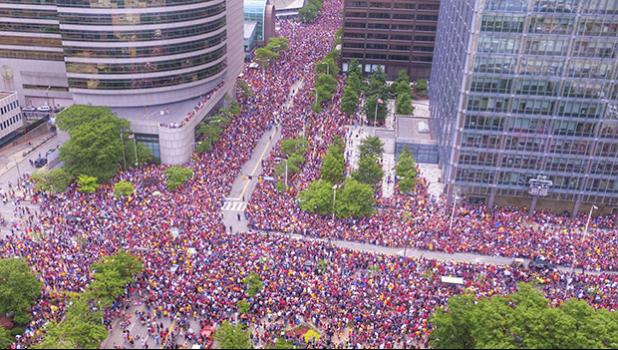 In this June 22, 2016 photo, the crowd wait in the parade route in downtown Cleveland to celebrate the Cavaliers basketball team's NBA championship. This photo showing a crowd of nearly one million people engulfing major roadways was not taken during a President Donald Trump rally in Houston this week, as several people falsely claimed on social media.But the image circulating on social media was snapped in June 2016 during a million-person parade that took place in downtown Cleveland to celebrate the Cavaliers' NBA championship. Using a drone, Bruce Bishop and Matt Mishak took the photo while covering the event for the Chronicle-Telegram, a newspaper in Elyria, Ohio. (Bruce Bishop/Elyria Chronicle-Telegram via AP) Crowd in the parade route in downtown Cleveland to celebrate the Cavaliers basketball team