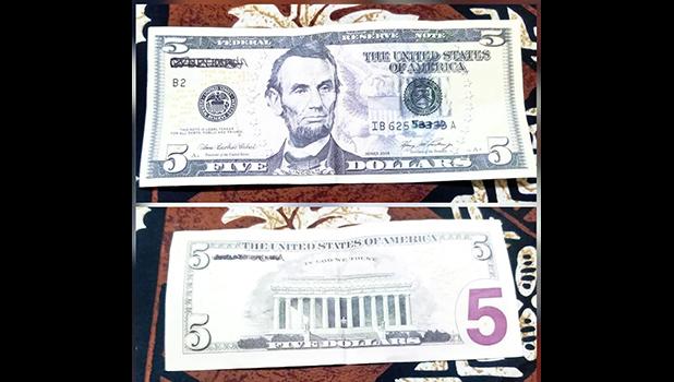 Photos of back and front of fake $5 bill.