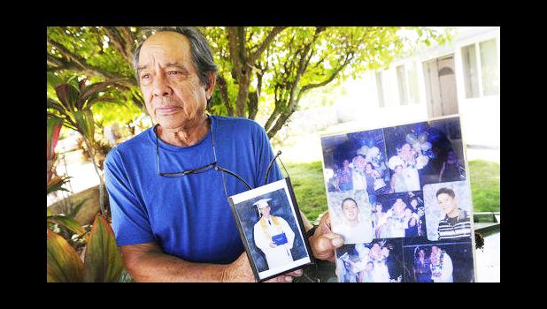 In this Monday, July 10, 2017 photo, Clifford Kang, father of soldier Ikaika E. Kang, poses with photo of his son in Kailua, Hawaii. Ikaika E. Kang, an active-duty U.S. soldier, was arrested over the weekend on terrorism charges that accuse him of pledging allegiance to the Islamic State group and saying he wanted to "kill a bunch of people." (Bruce Asato/The Star-Advertiser via AP) In this Monday, July 10, 2017 photo, Clifford Kang, father of soldier Ikaika E. Kang, poses with photo of his son in Kailua, Hawaii. Ikaika E. Kang, an active-duty U.S. soldier, was arrested over the weekend on terrorism charges that accuse him of pledging allegiance to the Islamic State group and saying he wanted to "kill a bunch of people." (Bruce Asato/The Star-Advertiser via AP)