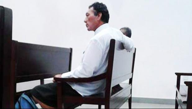 Father and son sitting in the courtroom