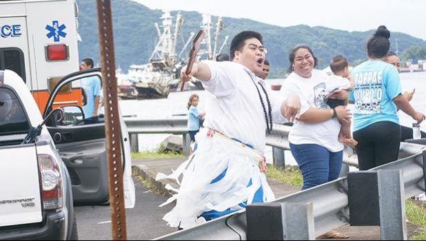Sean Tilo and his sister Sherry cheering and dancing for their village fautasi, the Aua Paepaeulupo’o during the second heat at yesterday’s fautasi regatta for the 2017 Annual Flag Day Fautasi Faigamea i le Tai. The boat came in first in heats overall with a time of 35:19.13. The Championship Race is not set for Saturday. [Photo: EM]