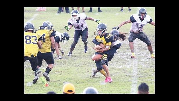 Tafuna’s middle linebacker – Penei Pavihi, causing a fumble in the first half of their varsity battle last Saturday, hits Nu’uuli Voc-Tech’s Hans Misa hard. Tafuna defeated Nu’uuli 36 - 6. [photo: TG]