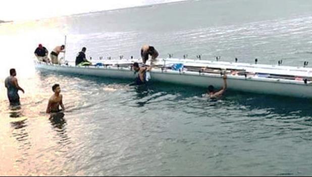 Fagaalu's Fetu ole Afiafi crew in the water with the boat
