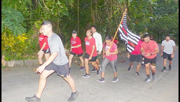 Members of the community march to honor fallen firefighters