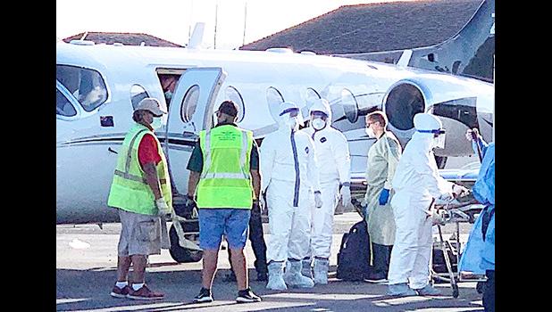 Ground crew and medical personnel on the tarmac at the Pago Pago International Airport 
