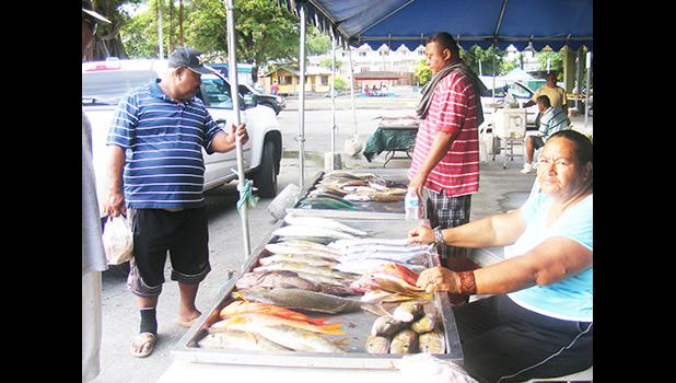 A woman selling fish at the Fagatogo Marketplace in 2016
