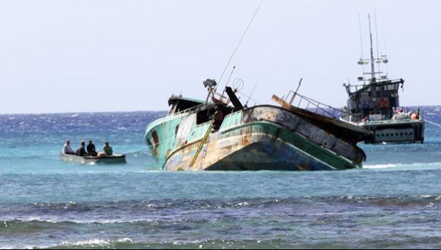 Workers prepare the 79-foot Pacific Paradise commercial fishing vessel for salvage off the shore of Honolulu, Thursday, Oct. 19, 2017. The boat that ran aground off Honolulu while transporting foreign fishermen to work in Hawaii’s commercial fishing industry has raised new questions about the safety and working conditions for foreign laborers in this unique U.S. fleet. (AP Photo/Caleb Jones) Workers prepare the 79-foot Pacific Paradise commercial fishing vessel for salvage off the shore of Honolulu, Thursday, Oct. 19, 2017. The boat that ran aground off Honolulu while transporting foreign fishermen to work in Hawaii’s commercial fishing industry has raised new questions about the safety and working conditions for foreign laborers in this unique U.S. fleet. (AP Photo/Caleb Jones)